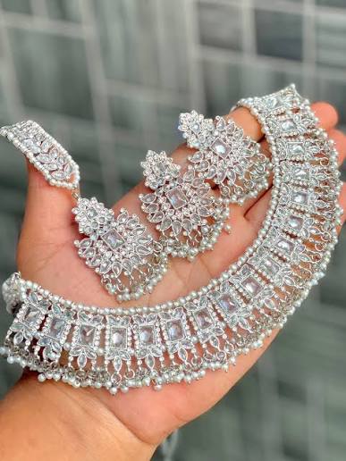 Silver imitation bridal jewellery set with ornate necklace and floral earrings